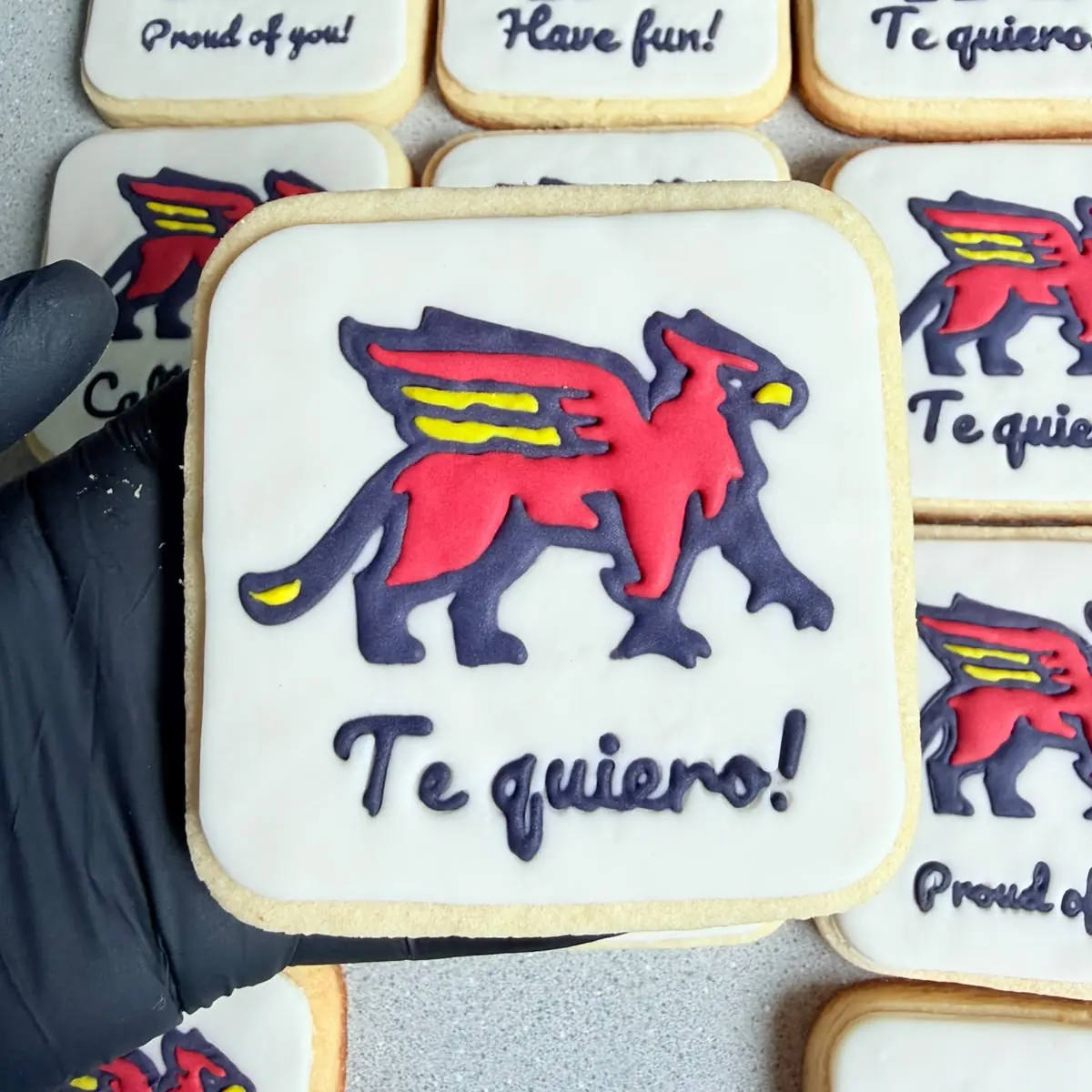 Square cookie decorated with a red and navy griffin logo